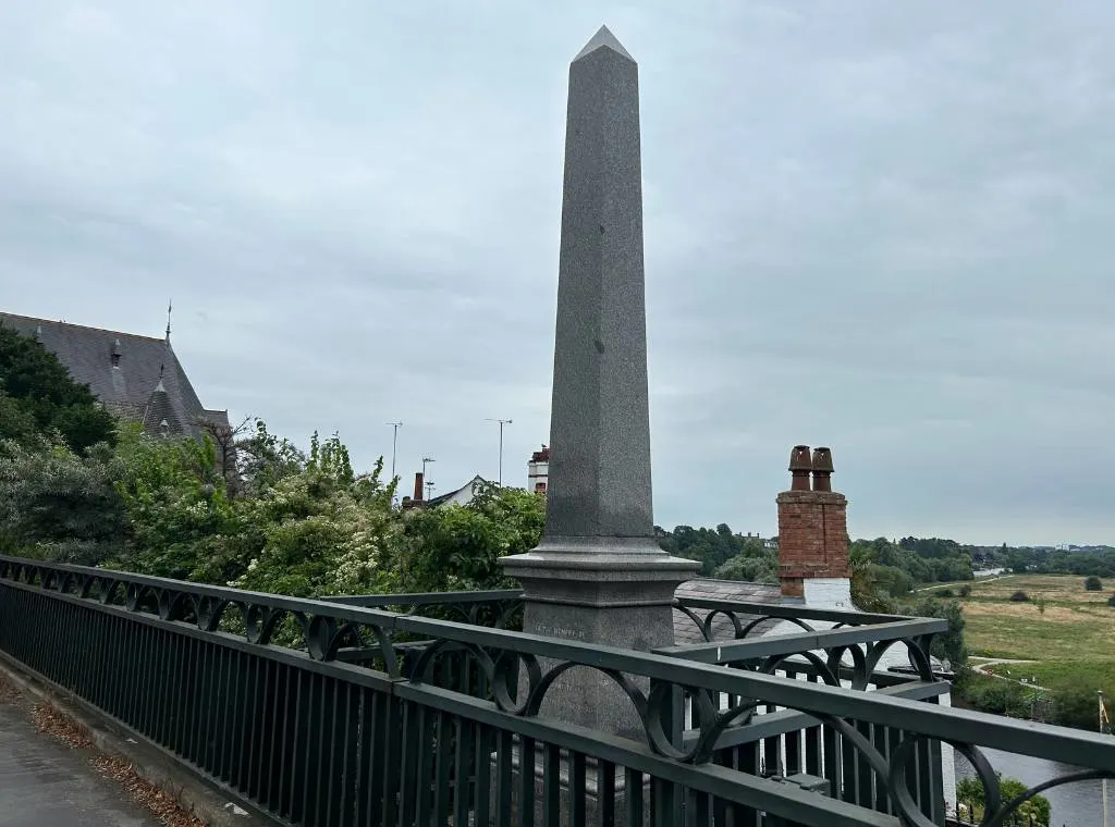 memorial to george marsh, a plinth with an inscription on behind an iron fence