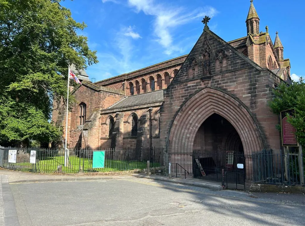 the exterior of st johns church showing the front of the church and the entrance