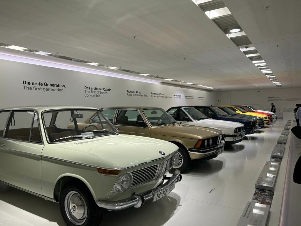 a collection of BMW 3 series cars lined up in a row