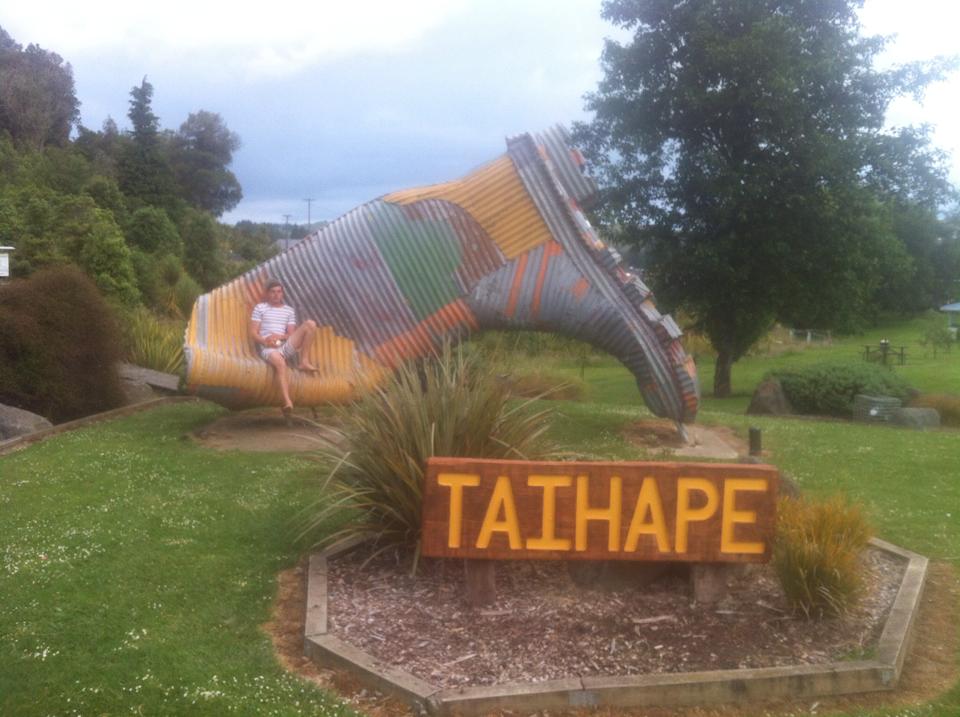 Me sitting on a giant gumboot made from metal in Taihape