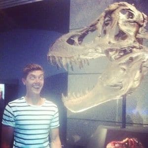 man and a dinosaur skull