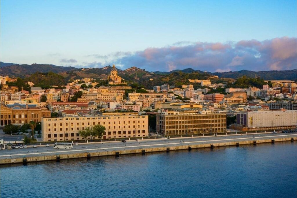 View of Messina with the sea in the foreground and the city buildings in the background