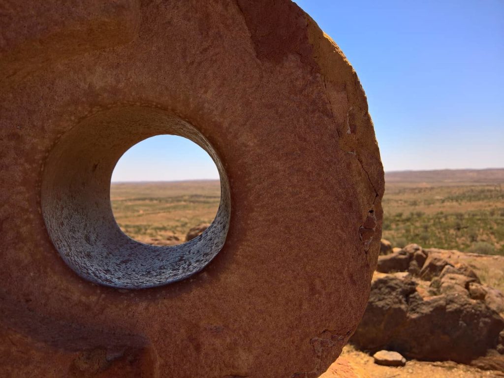 close up of a circular desert sculpture with a hole in the centre in broken hill