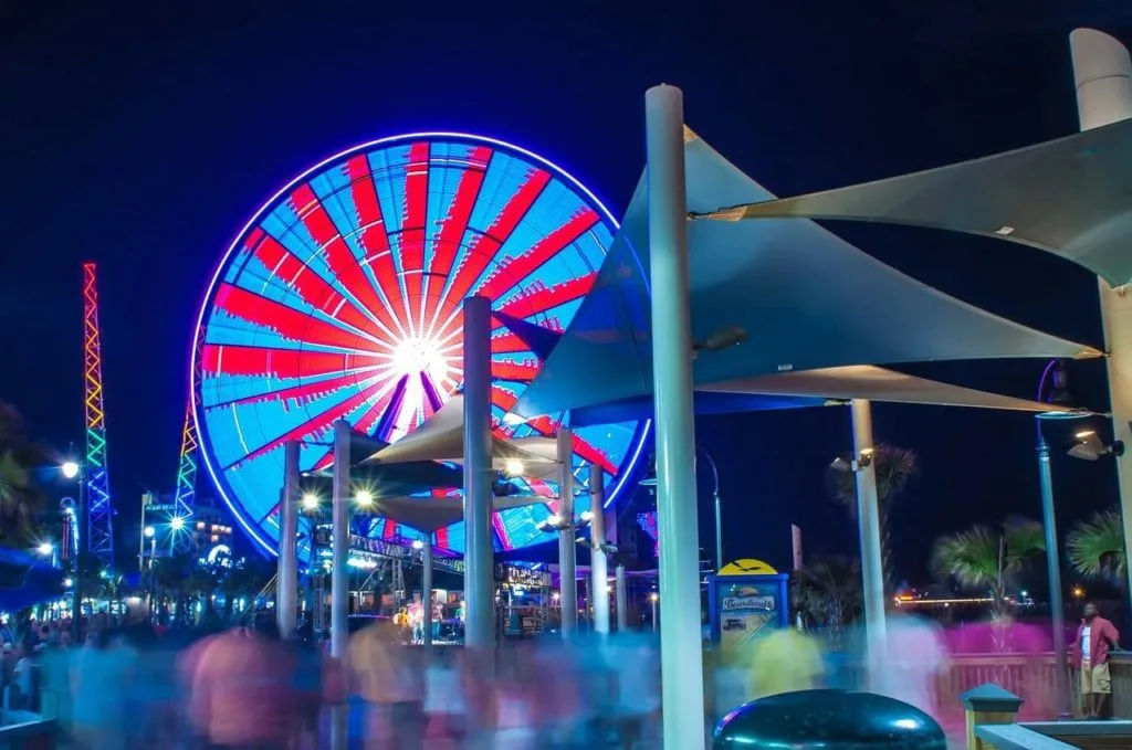 boardwalk at Myrtle Beach with a Ferris Wheel in neon light visible