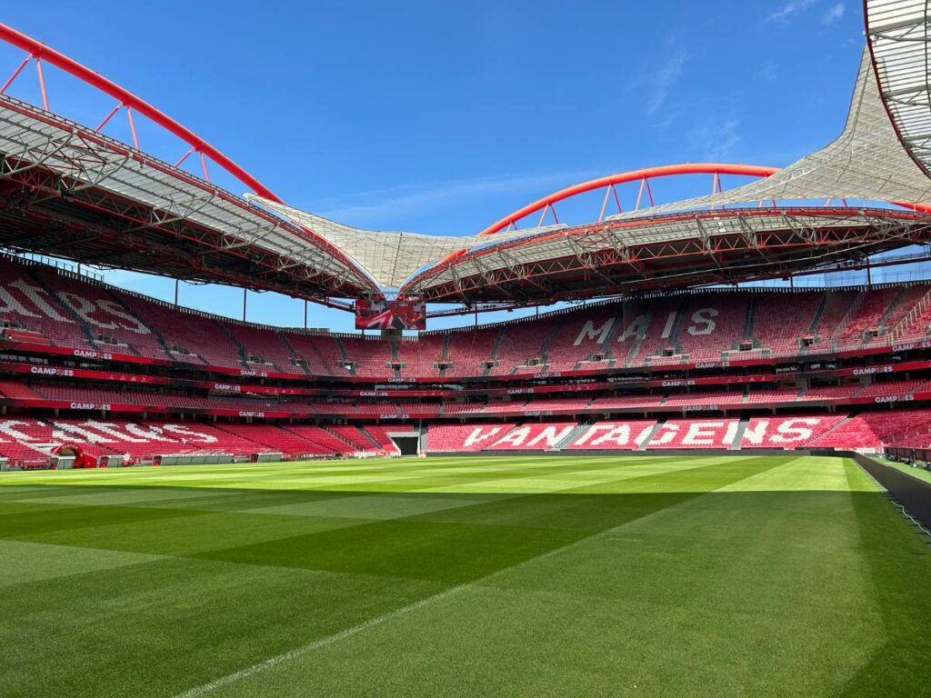 The inside of the Estádio da Luz with two stands and the pitch visible