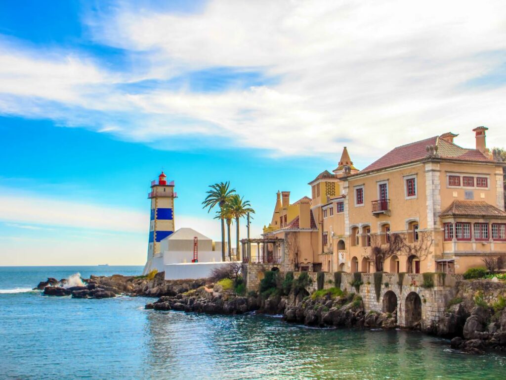 lighthouse in Cascais with houses behind it