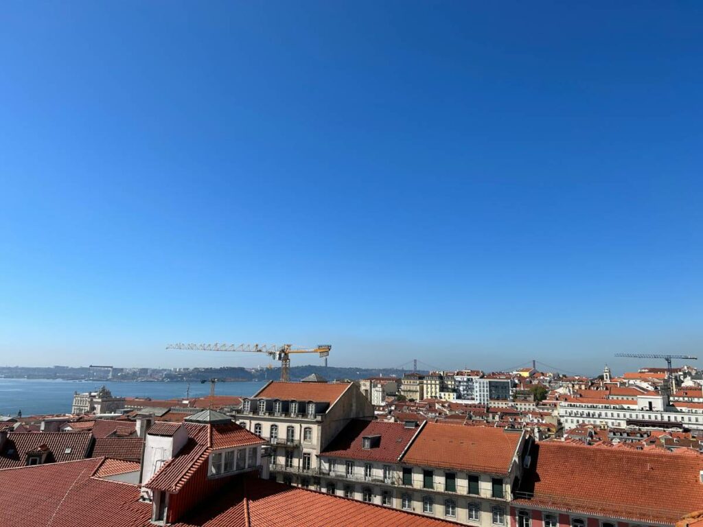 The Lisbon skyline with terracotta roofs and cranes visible