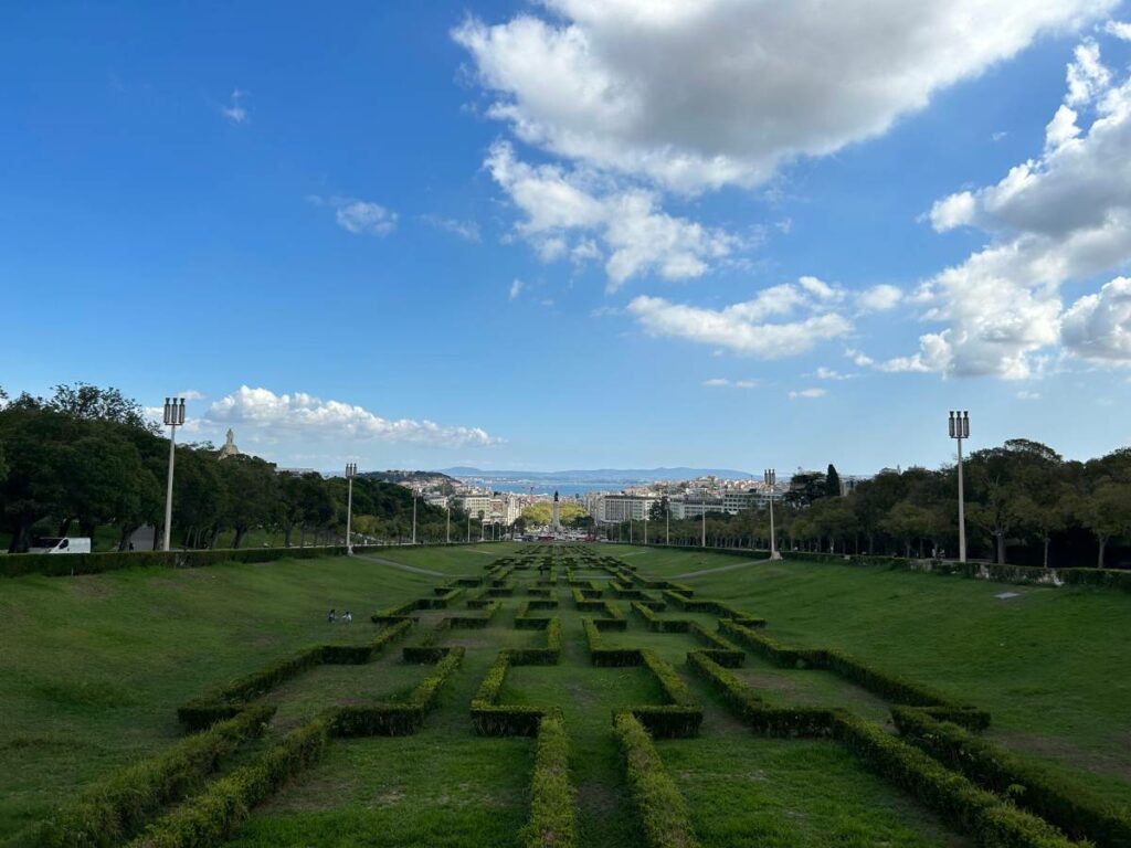 looking down at parque eduardo vii from the top of the park with downtown Lisbon visible in the distance