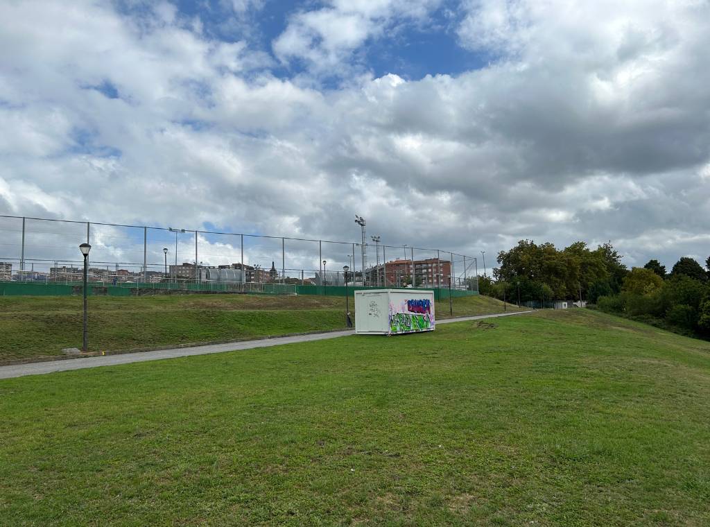 a field and a football court in parque extebarria