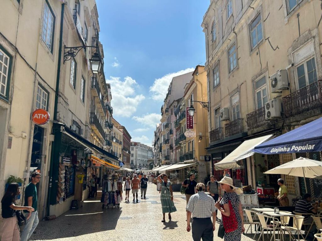 walking down a busy street in Lisbon