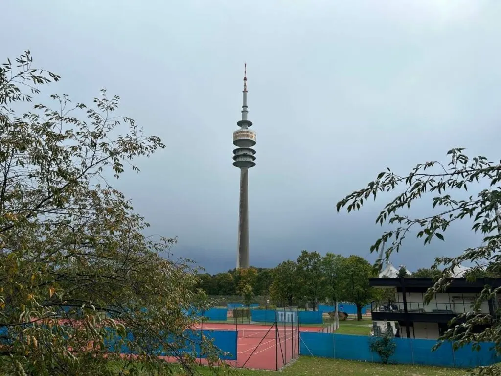 the Olympic Tower in front of tennis courts
