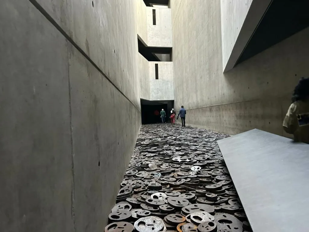 the fallen leaves exhibit at the Jewish Museum in Berlin with faces punched into steel