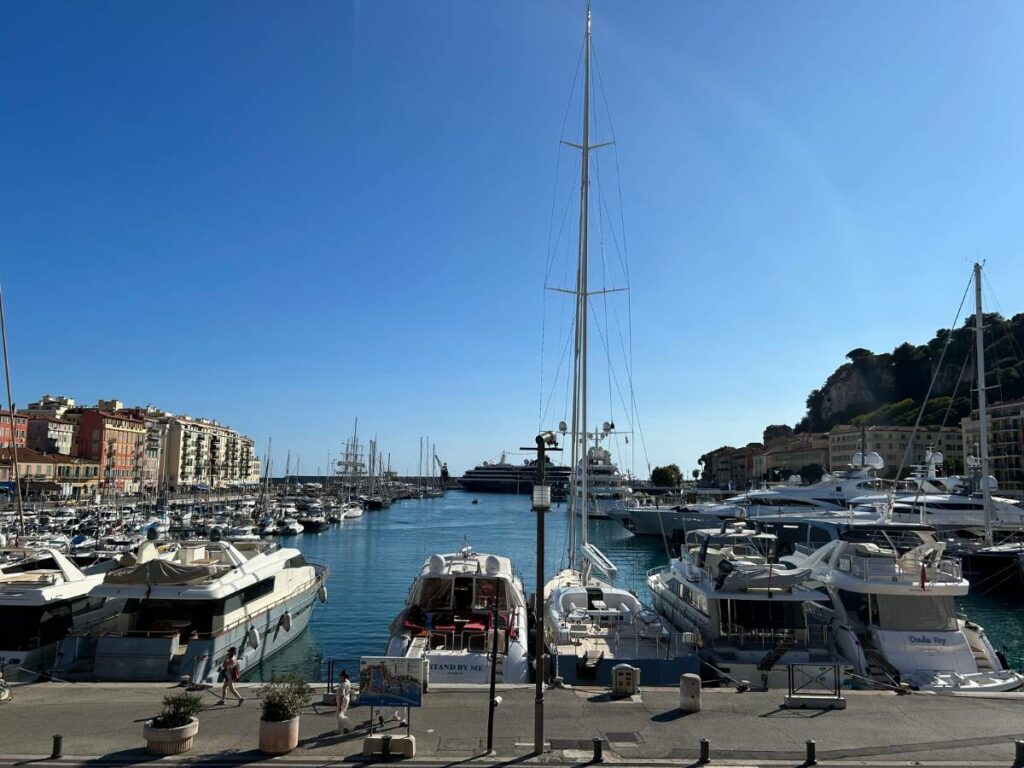 marina in nice with numerous boats docked in the blue water