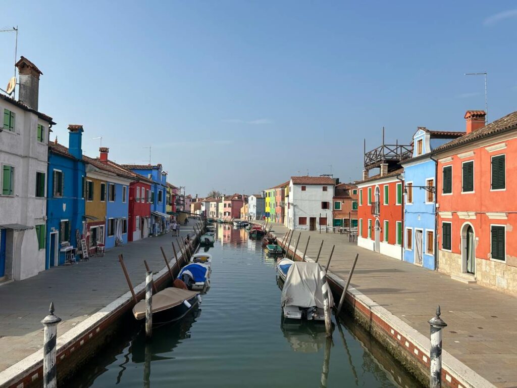 canal on the island of Burano with colorful houses either side