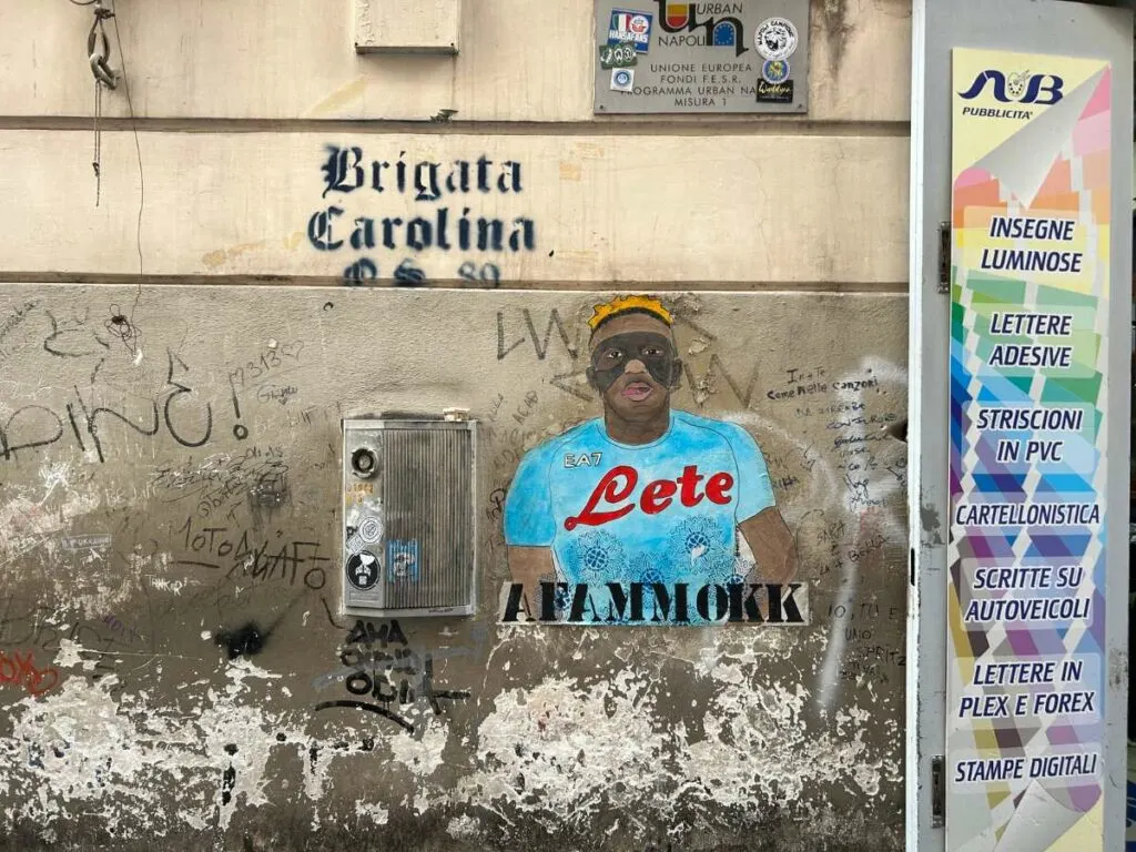 a small mural of Napoli player Victor Osimhen on a wall in the Spanish Quarter