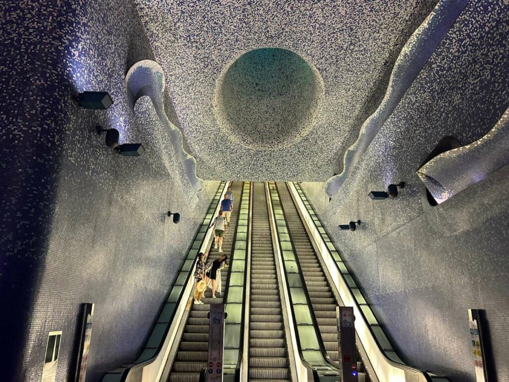 the inside of Toledo metro station in Naples with escalators visible