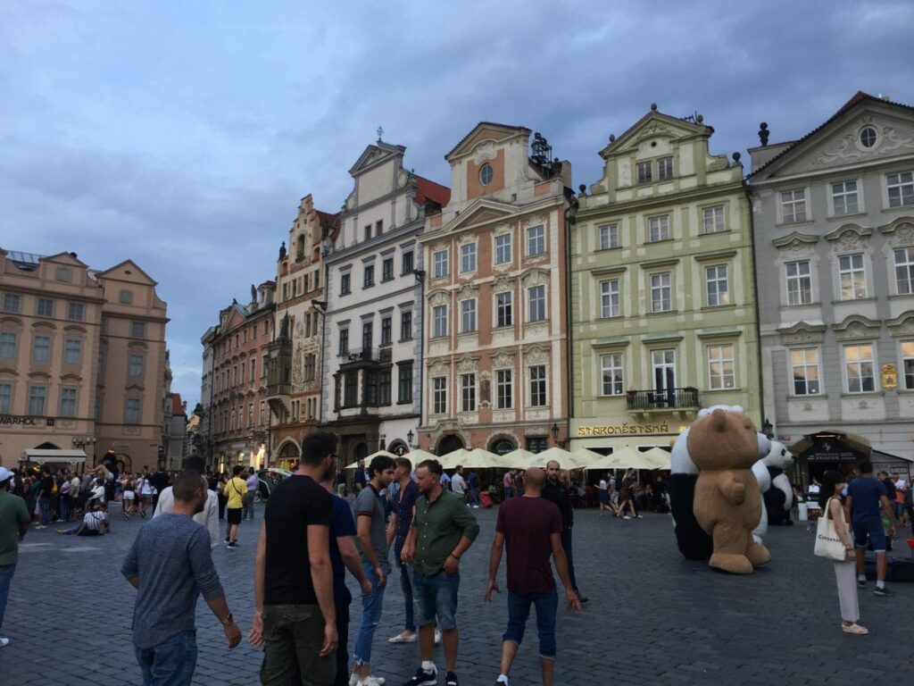 A busy centre of Prague with lots of tourists in the old town
